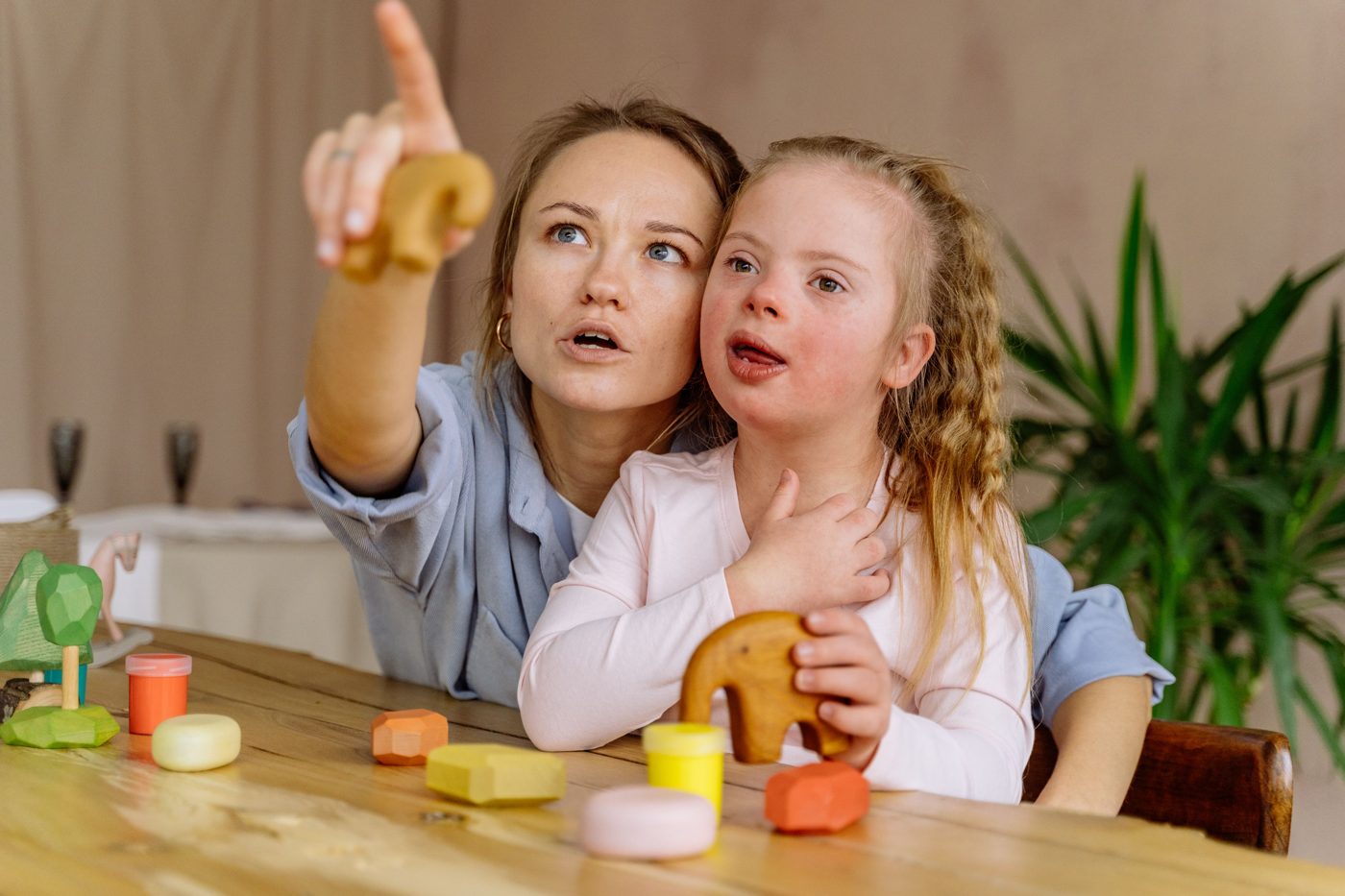 Teacher and child playing with clay